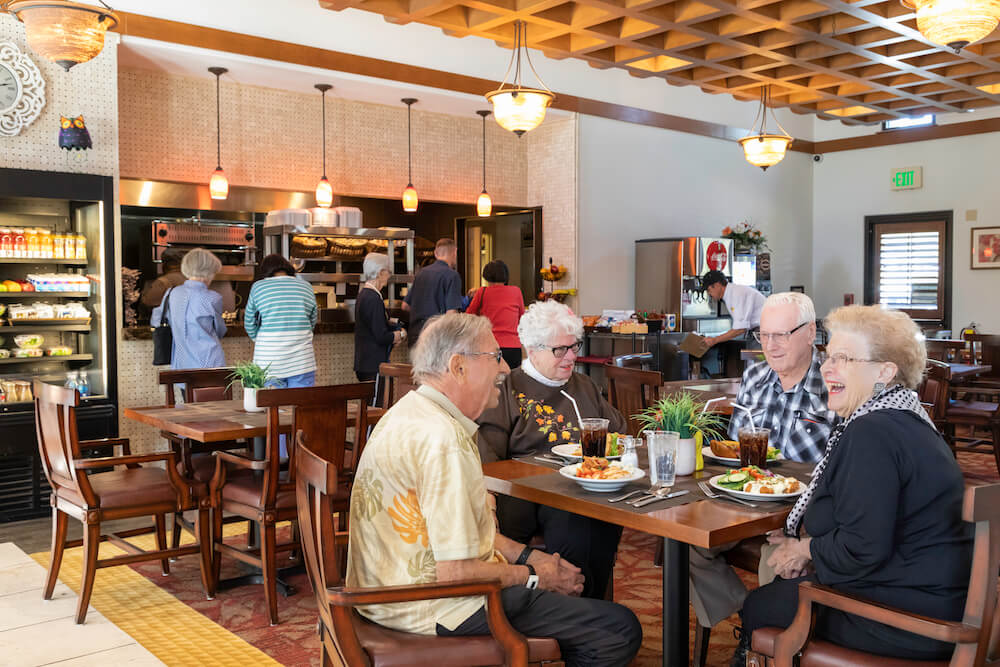 Four friends sitting at a table in the dining room